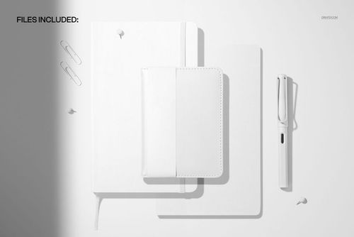 Top view of leather calendars and notebook mockup in white, with pen, paper clips, and push pins on a light background.