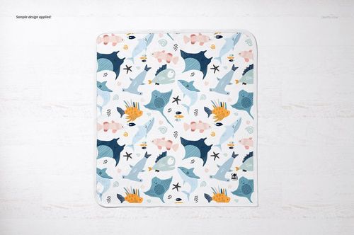 Square cotton baby blanket mockup featuring colorful marine life illustrations, shown from above on a light background.