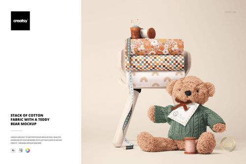 PSD mockup showing assorted cotton fabric rolls with floral and rainbow designs, accompanied by a teddy bear and sewing accessories.