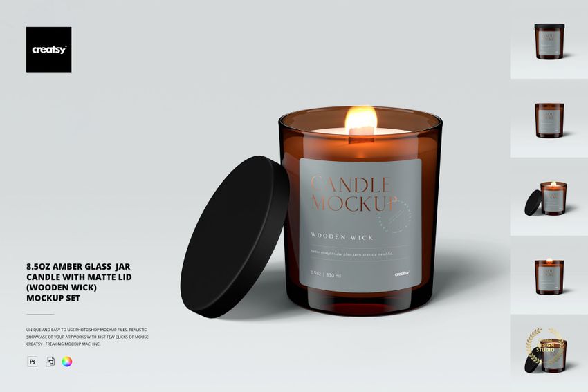 Amber glass jar candle with a matte black lid, wooden wick, and gray label shown in a front view mockup scene.