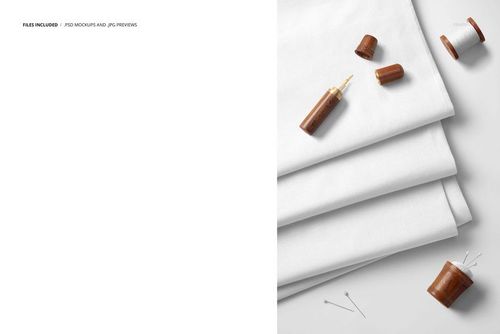 PSD mockup featuring layers of white cotton fabric arranged in a stack, with sewing accessories placed on the right side.