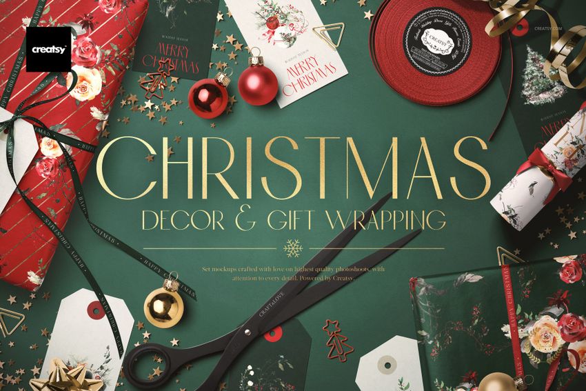 Christmas gift wrapping mockup scene with green and red wrapping paper, ornaments, ribbons, cards, and scissors viewed from above.