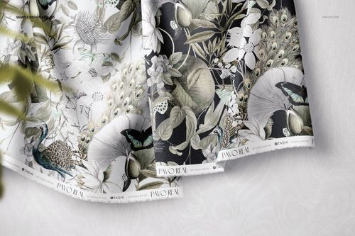 Hanging fabrics mockup displaying intricate botanical and bird motifs, viewed from above with visible texture.