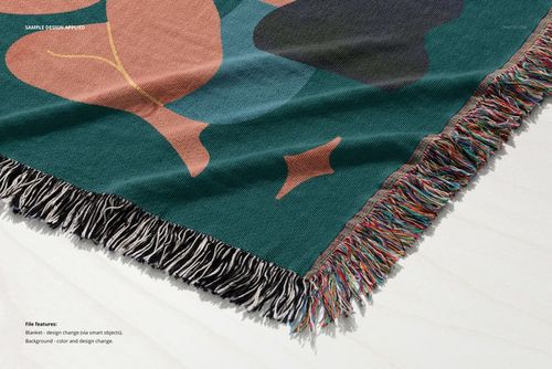 Jacquard woven throw blanket mockup with multicolored fringe, featuring abstract shapes in green and brown tones.