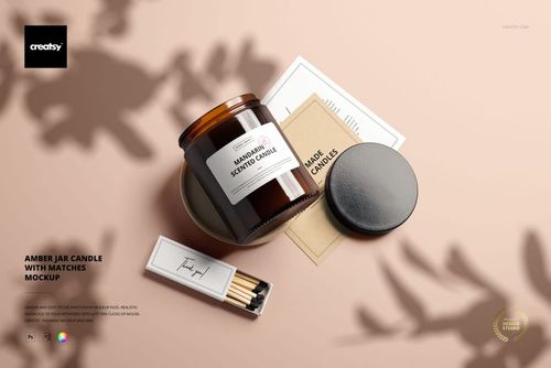 PSD mockup featuring an amber candle jar, matchbox, and assorted stationery items from a top perspective.