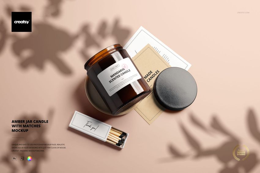 PSD mockup featuring an amber candle jar, matchbox, and assorted stationery items from a top perspective.