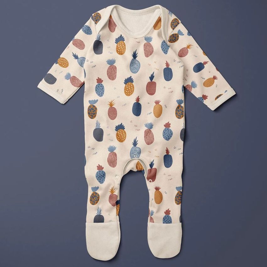 Baby chest rompersuit mockup featuring a cream-colored onesie with a playful pineapple pattern in muted tones on a solid background.