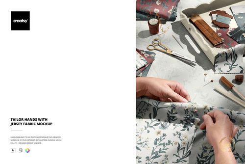 Close-up of tailor’s hands arranging floral patterned jersey fabric, surrounded by sewing accessories and mockup props.