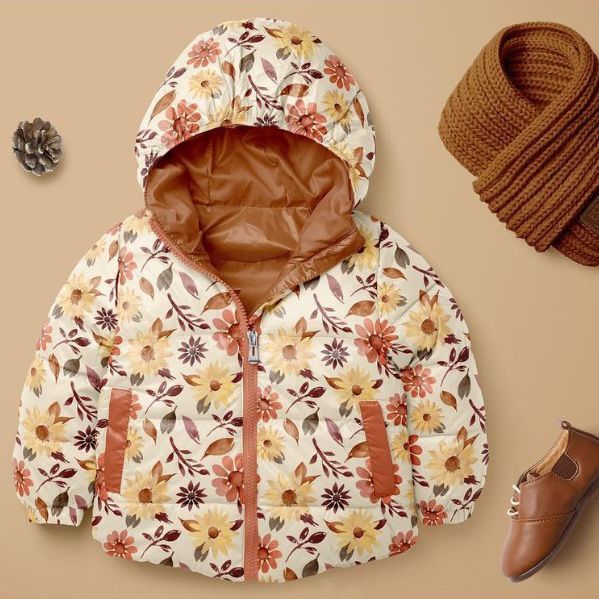 Kids winter set mockup featuring a floral-patterned jacket with brown accents, displayed on a beige background with a scarf, shoe, and pinecone.