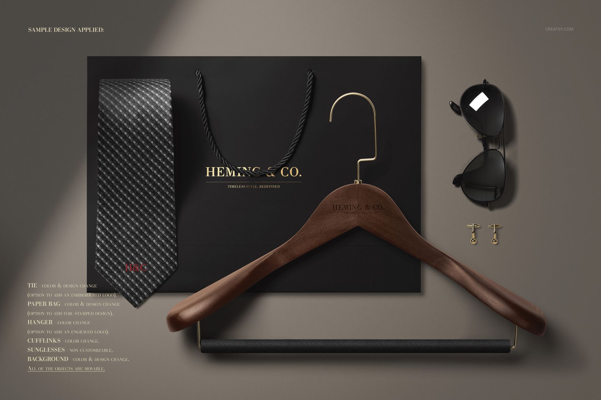 Top view of men's fashion mockup set with a textured tie, black paper bag, wooden hanger, sunglasses, and gold cufflinks.