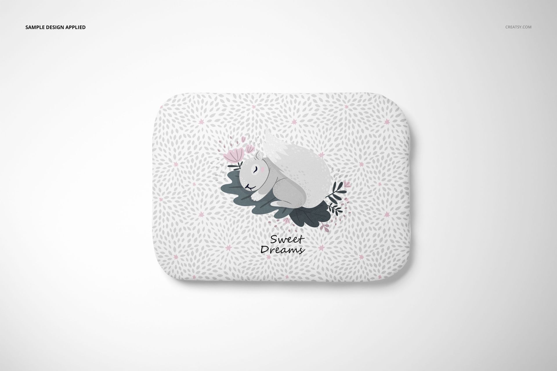 Front view of a baby pillow mockup with a cute squirrel graphic, leafy accents, and subtle dotted background.