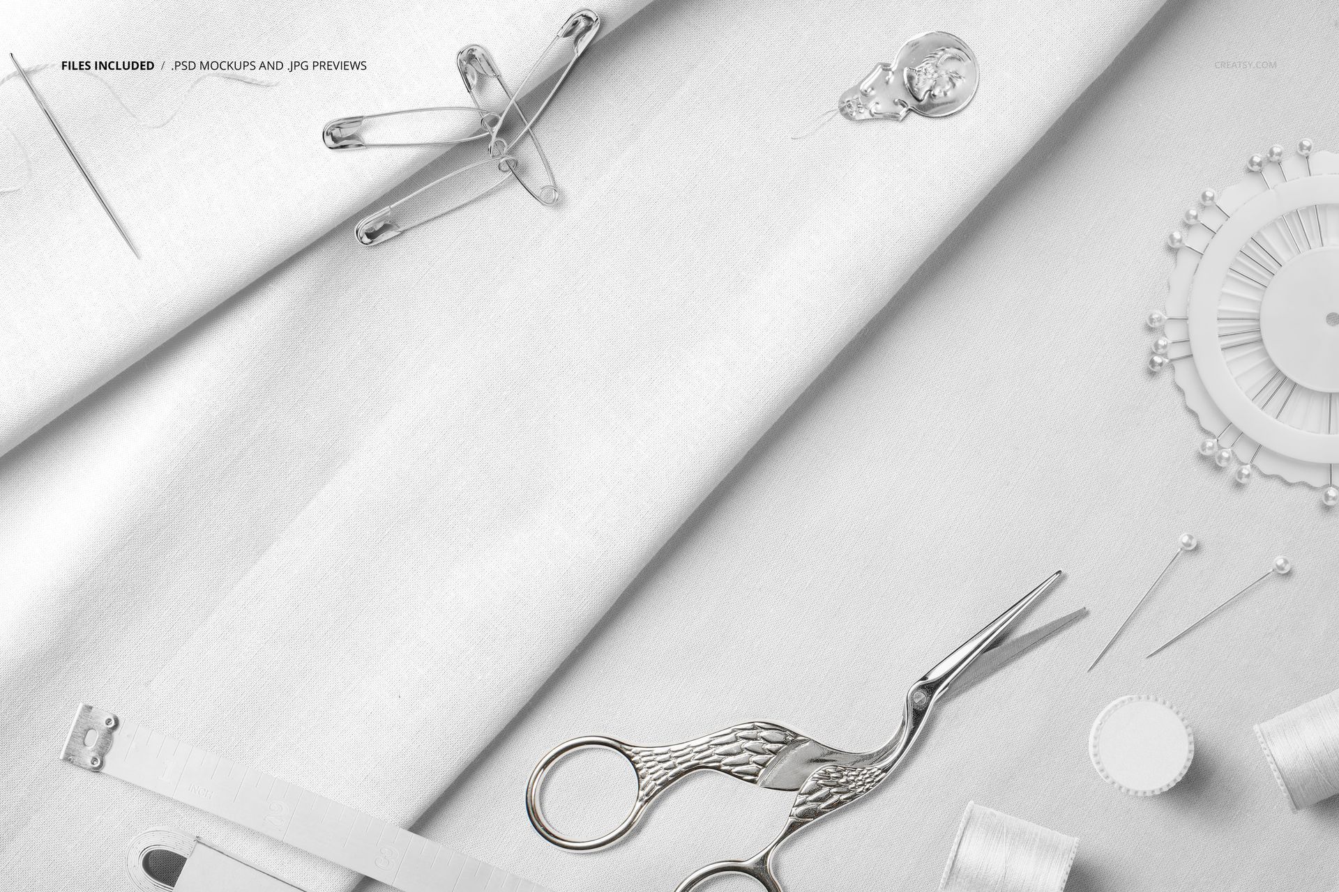 PSD mockup showing cotton textiles alongside sewing tools including a pinwheel, thimble, and spools of thread.