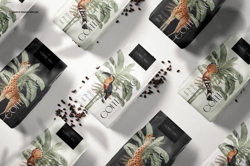 PSD mockup of paper coffee bags with nature-inspired artwork, displayed from above with coffee beans scattered around.