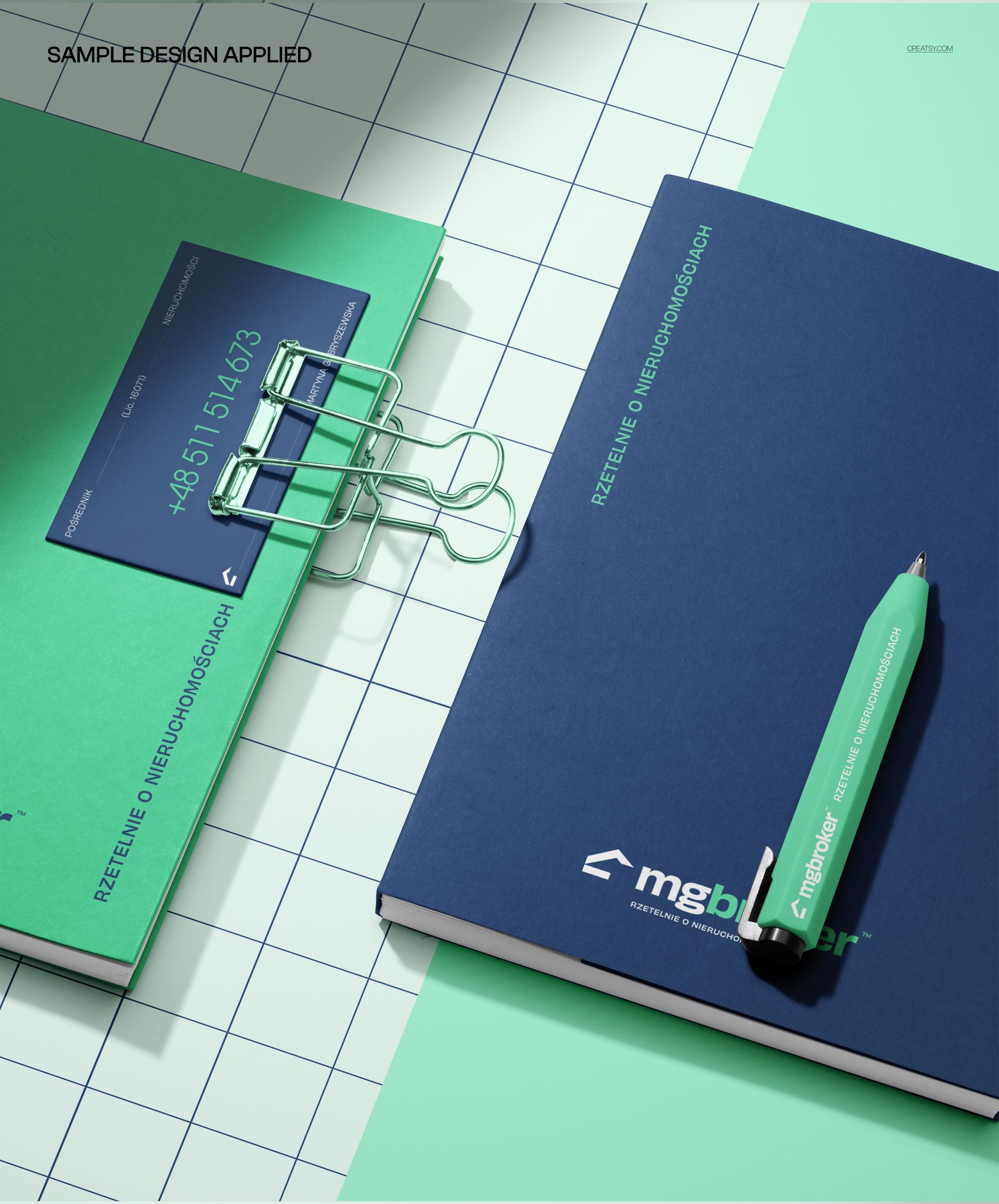 PSD mockup featuring two planners, a business card, and a pen, all placed on a light grid-patterned background.