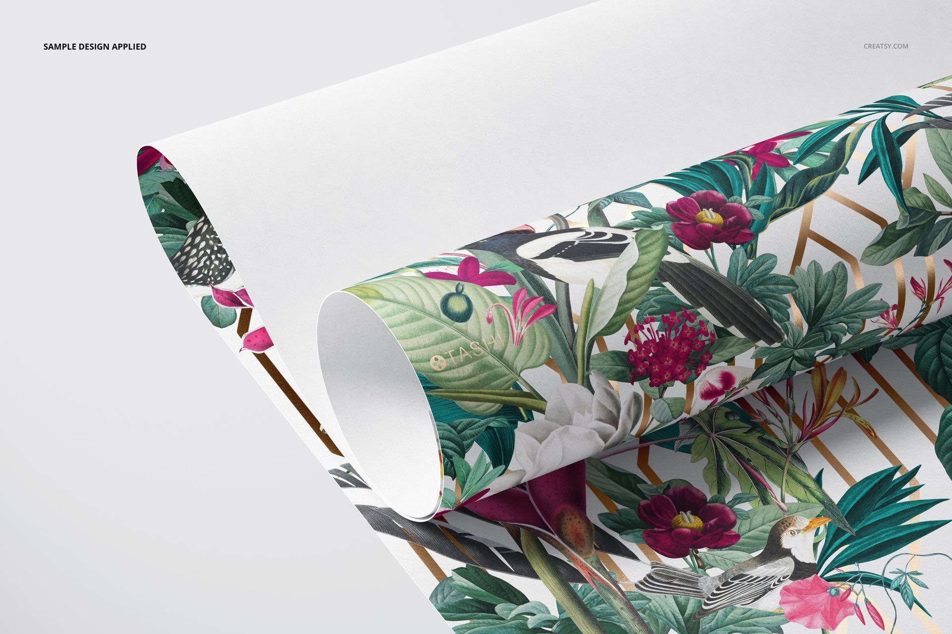 Rolled paper wallpaper mockup featuring a vibrant floral pattern with green leaves and pink flowers on a white background.
