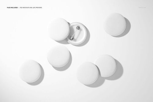 PSD mockup featuring several circular white plastic badges, with one badge flipped to reveal its pin fastener.