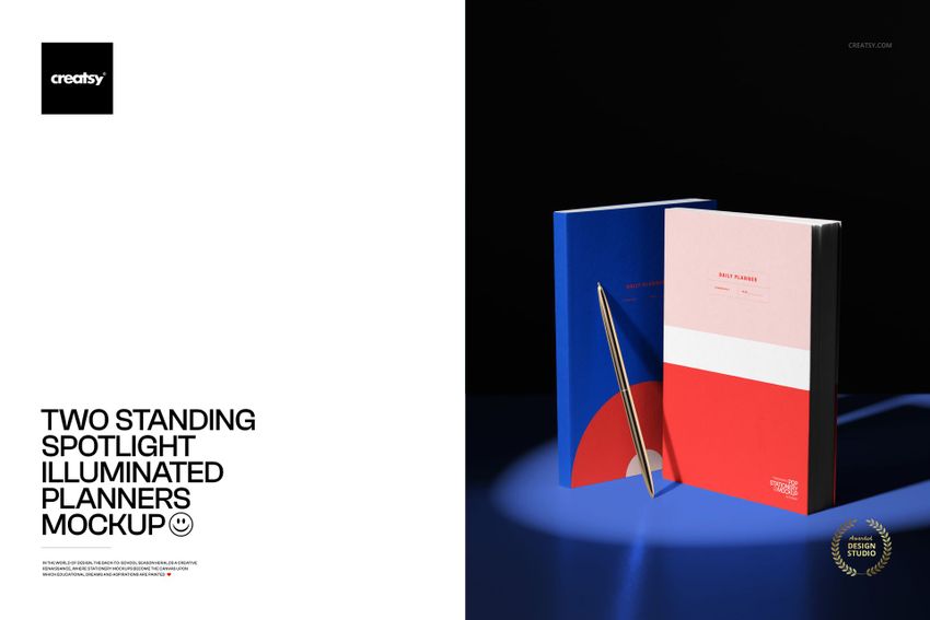 PSD mockup showing two colorful planners standing side by side under a circular pool of light with a pen accent.