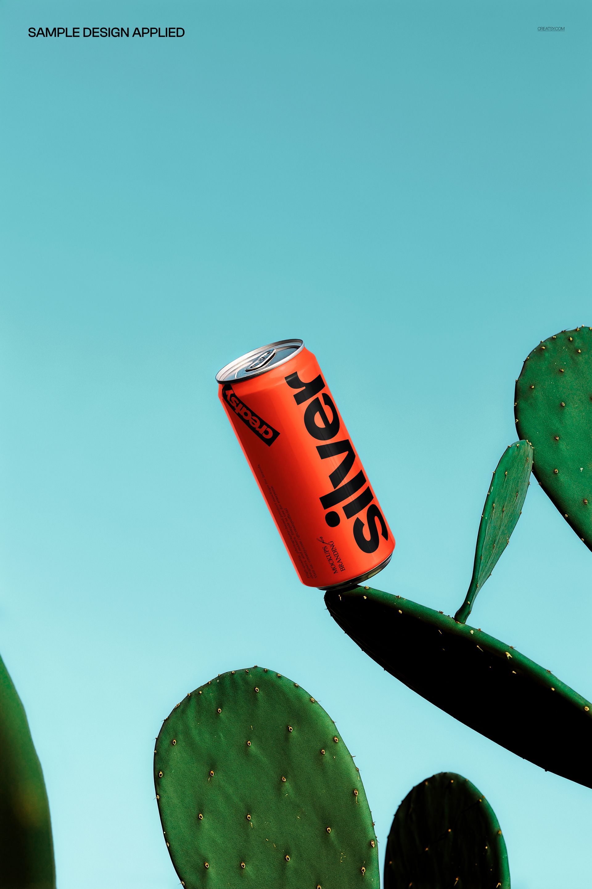Red drink can mockup floating above green cactus pads against a bright blue background, front view.