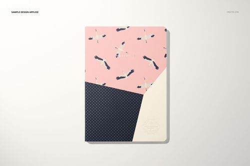 Notebook mockup with a cover split into pink with bird illustrations, navy blue with dots, and a cream section, top view.