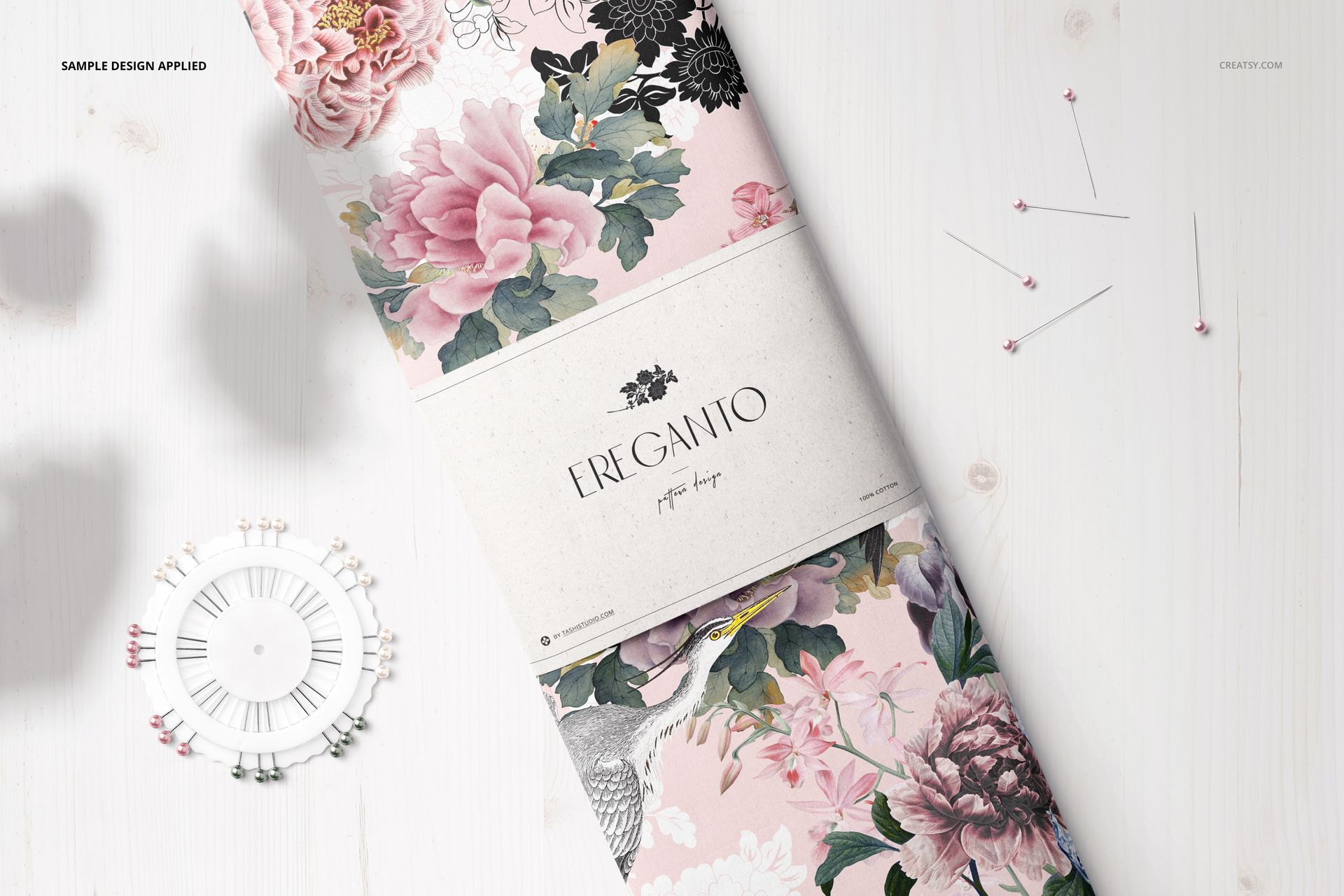 Floral fabric bolt mockup featuring pink and green flowers, shown from a top view on a white wood background.