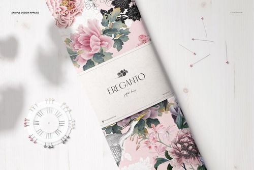 Floral fabric bolt mockup featuring pink and green flowers, shown from a top view on a white wood background.