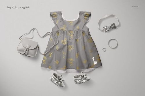 PSD mockup of a baby dress in gray with yellow botanical prints, shown with matching silver accessories on a light background.