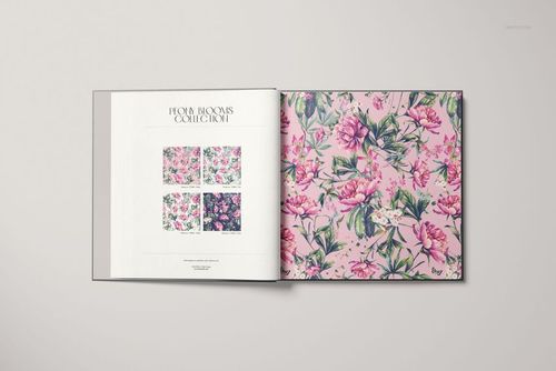 Front view of a wallpaper sample book mockup, displaying colorful floral patterns on a pale background.