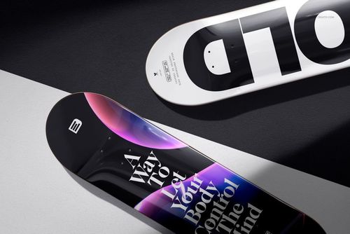 Mockup of epoxy resin skateboard decks with abstract and typographic artwork, displayed on angled surfaces.