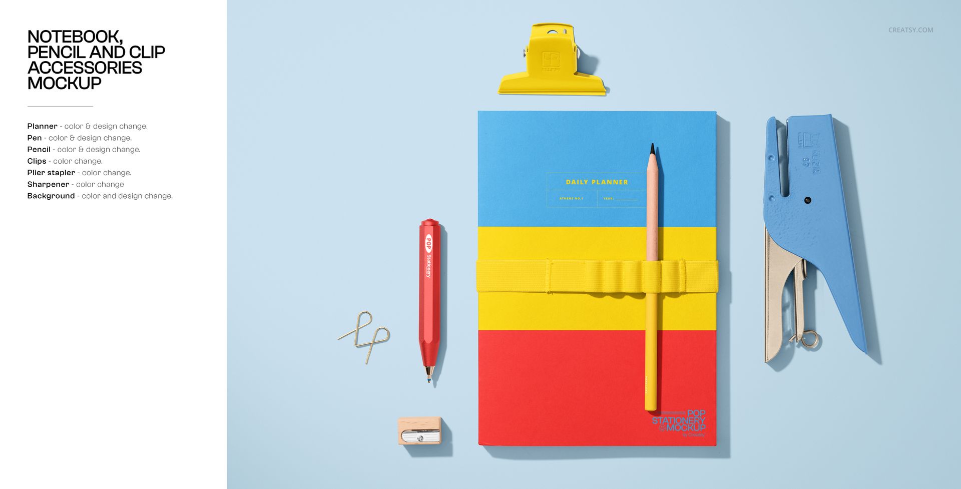 Stationery mockup featuring a notebook with bold color blocks, pencil, red pen, blue scissors, and yellow clip on a blue surface.