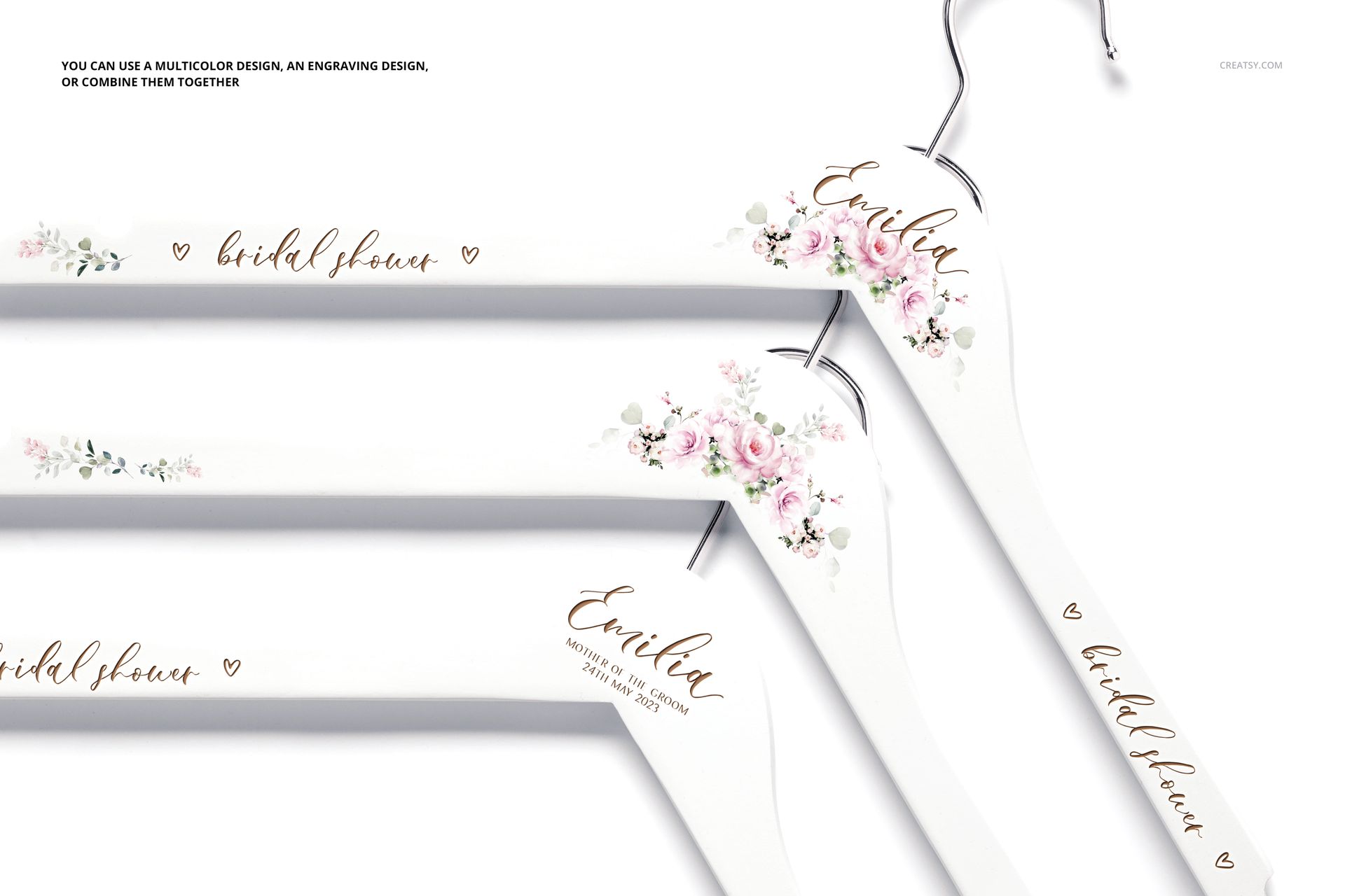 PSD mockup of personalized white hangers with elegant flower accents and scripted text, seen from above.