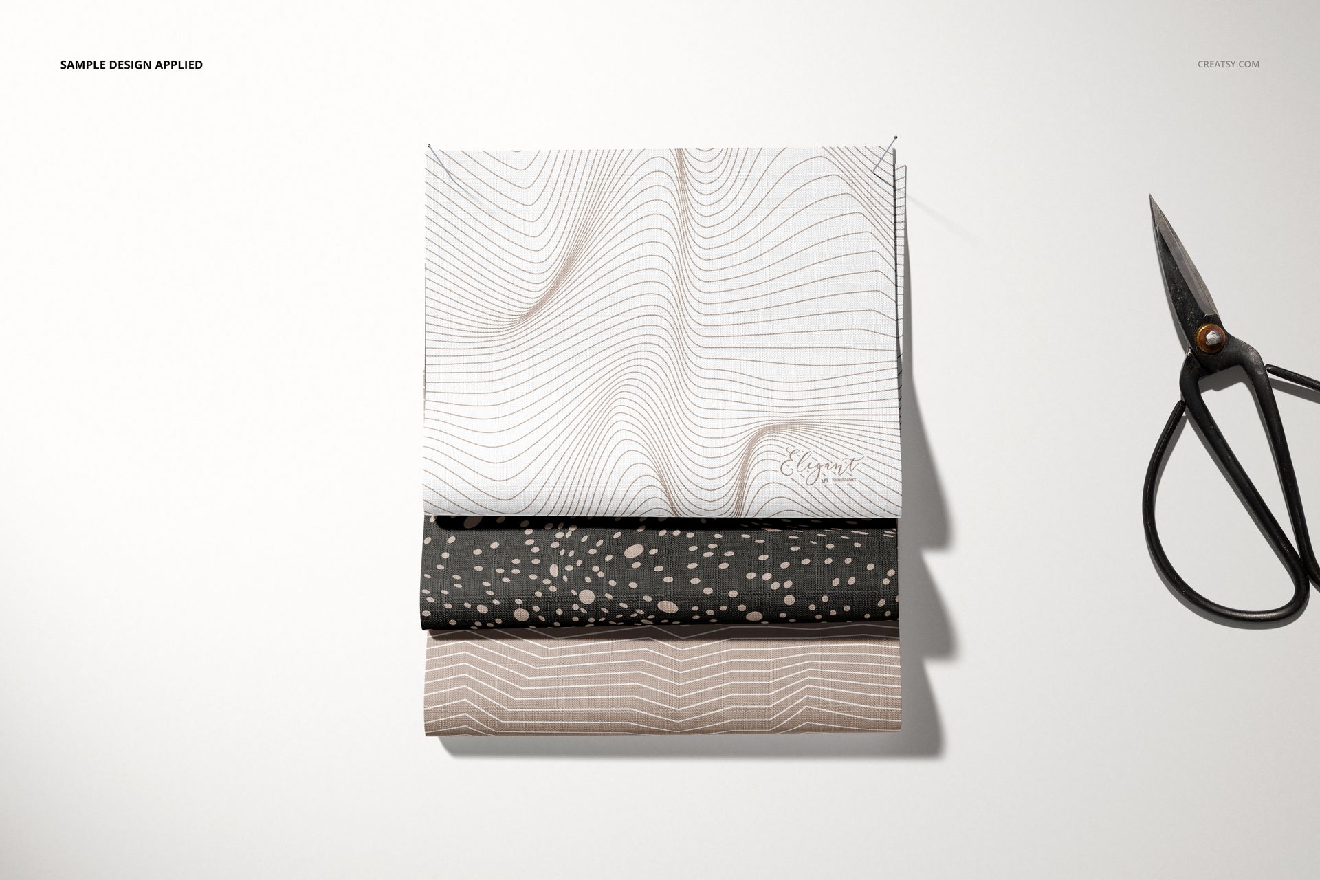 Fabric pieces mockup set displayed in a neat stack, each with unique minimalist patterns, photographed from a top perspective.