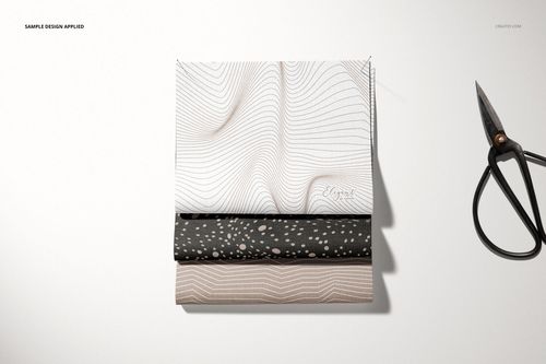 Fabric pieces mockup set displayed in a neat stack, each with unique minimalist patterns, photographed from a top perspective.
