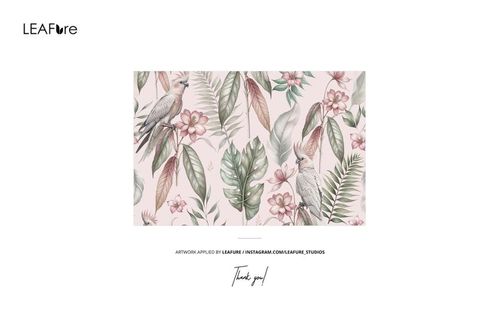 Wallpaper mockup featuring a vintage botanical pattern with tropical leaves, pink flowers, and birds on a pale background.