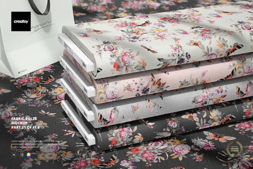 PSD mockup of fabric bolts arranged in a row, each with a unique floral print, viewed from a slightly angled perspective.