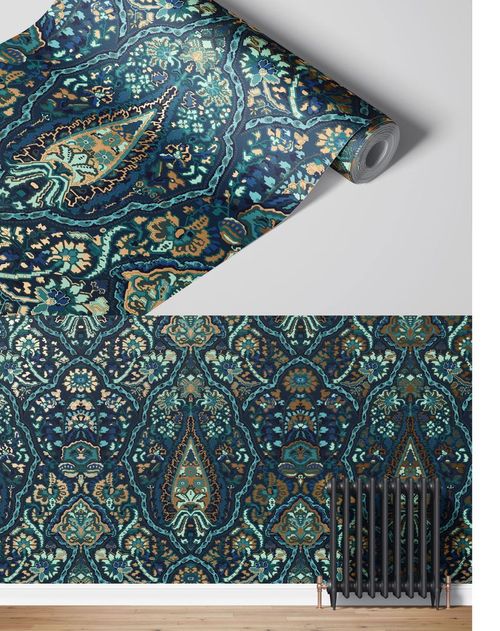 Front view of a paper wallpaper mockup showing a roll and a wall with ornate blue and teal motifs, next to a radiator.