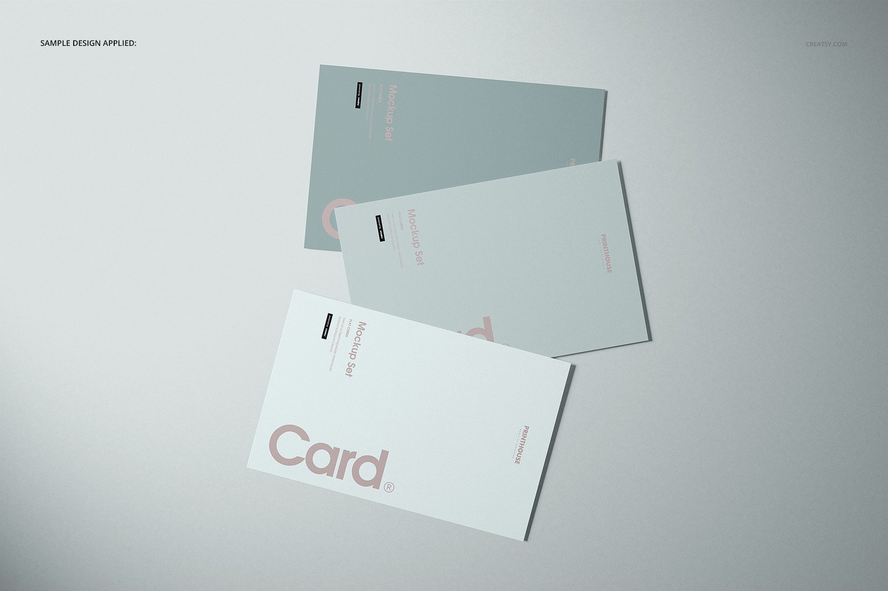 PSD mockup featuring three rectangular cards with modern, minimal patterns on a neutral background, viewed from above.