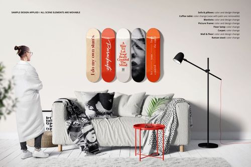 Skateboard decks wall décor mockup set displayed above a couch, with a red side table and monochrome blankets visible.