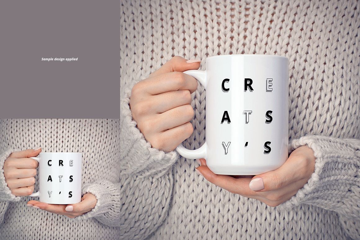 White ceramic mug held in both hands, featuring bold black letters, shown against a chunky knit sweater background.