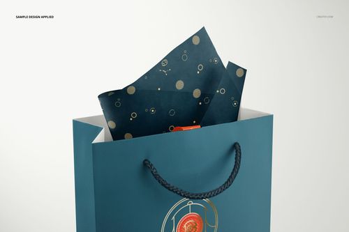 Blue jewelry bag with twisted rope handles and patterned tissue paper, shown in a realistic PSD mockup scene.