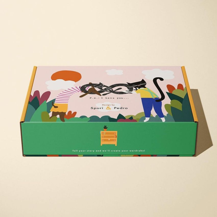 Mailing box mockup with colorful illustrated design showing two people, a cat, and abstract plants on a light background.