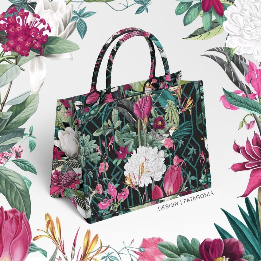 Canvas tote bag mockup featuring a vibrant floral pattern with pink, white, and green tones, set against a white background with botanical illustrations.