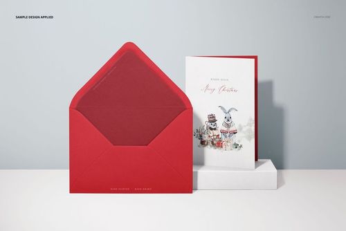 Front view of a 5x7 greeting card mockup set with a red envelope and illustrated card on a white surface.