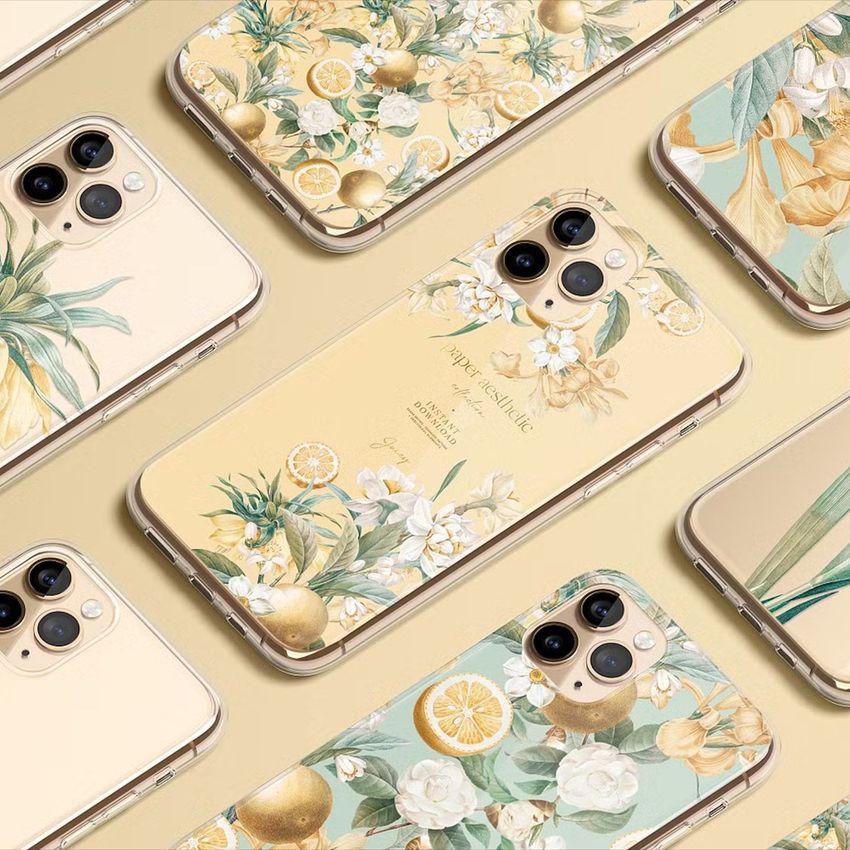 iPhone 11 Pro clear case mockup featuring tropical citrus fruit and floral designs in soft yellow and green tones on a beige background.