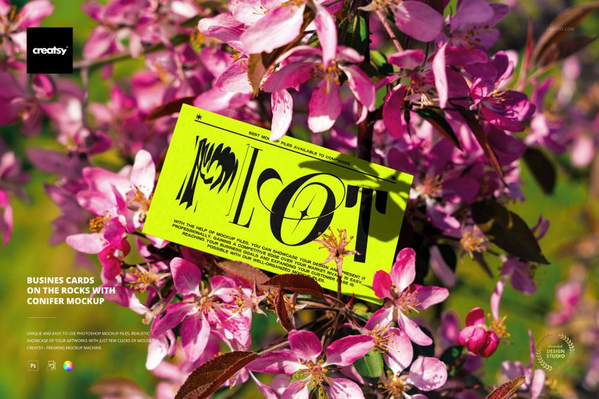 Bright green business card mockup resting among vibrant pink blossoms and green leaves on a flowering tree outdoors.