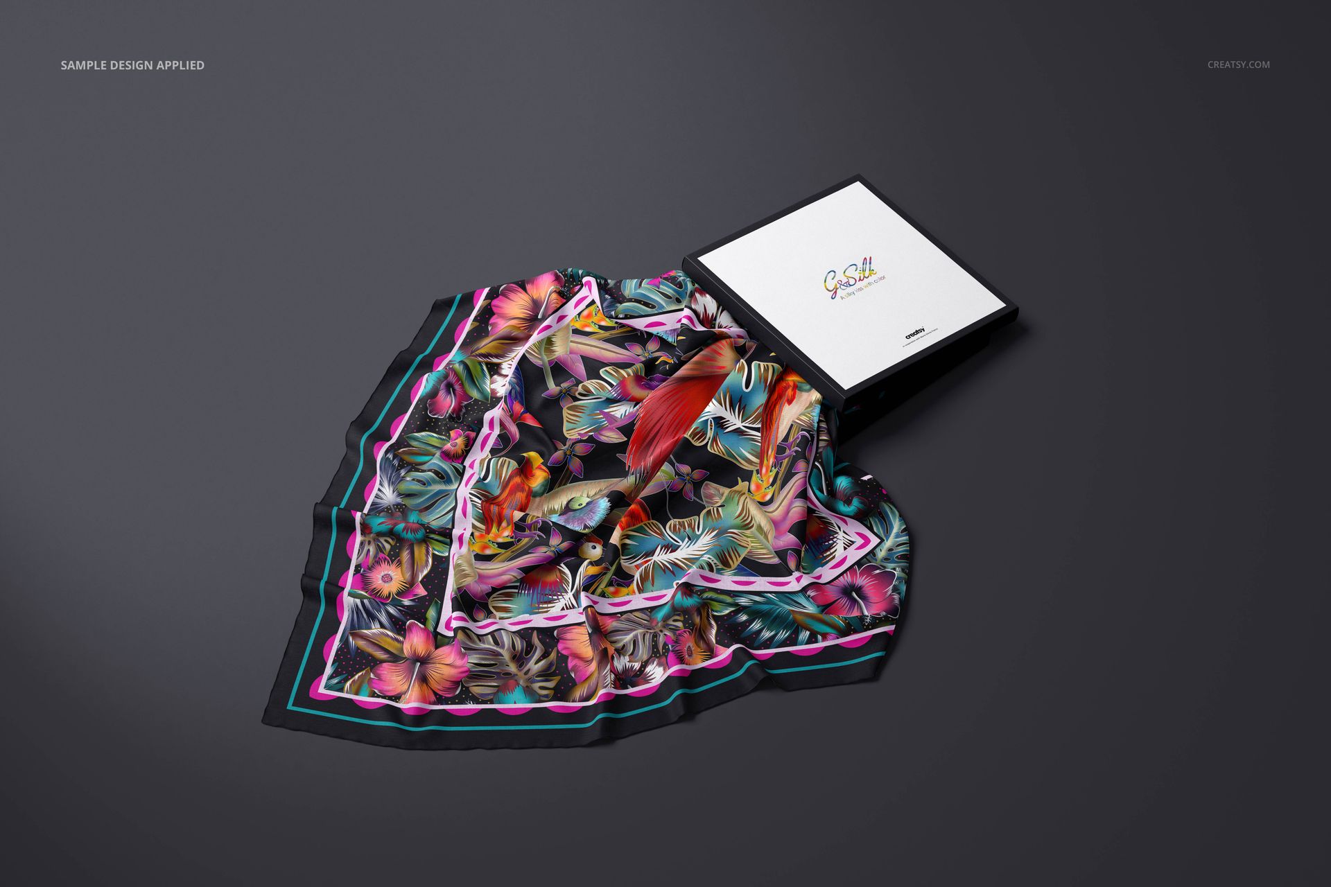 Lightweight cashmere scarf mockup featuring a colorful botanical print, shown with packaging box on gray surface.