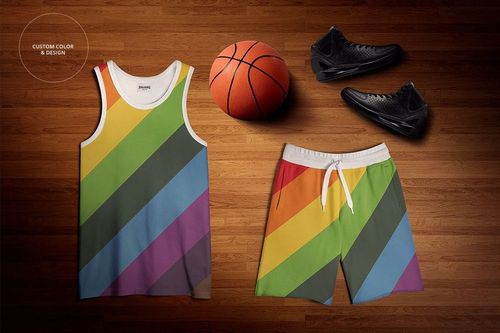 Basketball training uniform mockup set featuring a tank top and shorts with diagonal rainbow stripes on a wood floor.