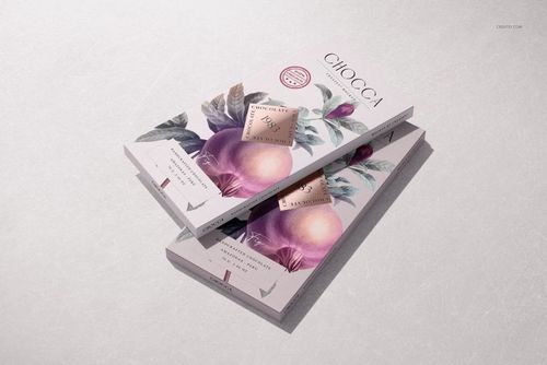 Two chocolate bar packaging mockups with botanical illustrations and soft pastel colors, viewed from above.
