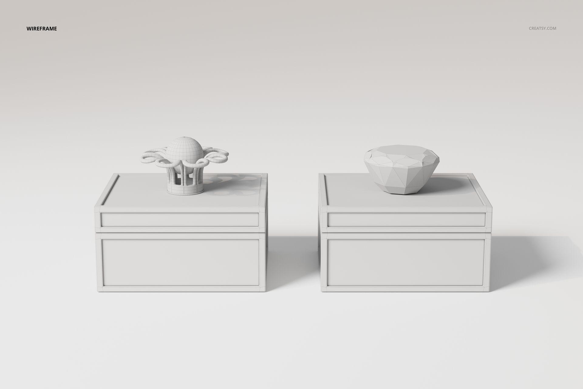 Front view of two art deco jewelry boxes in white, each with a geometric decorative lid, on a plain background.