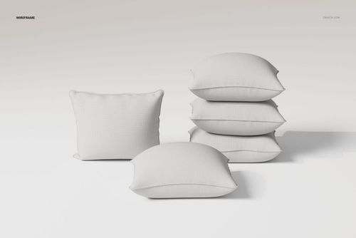 Front view of five white piped cushions arranged on a plain surface, featuring soft fabric texture and minimal shadows.