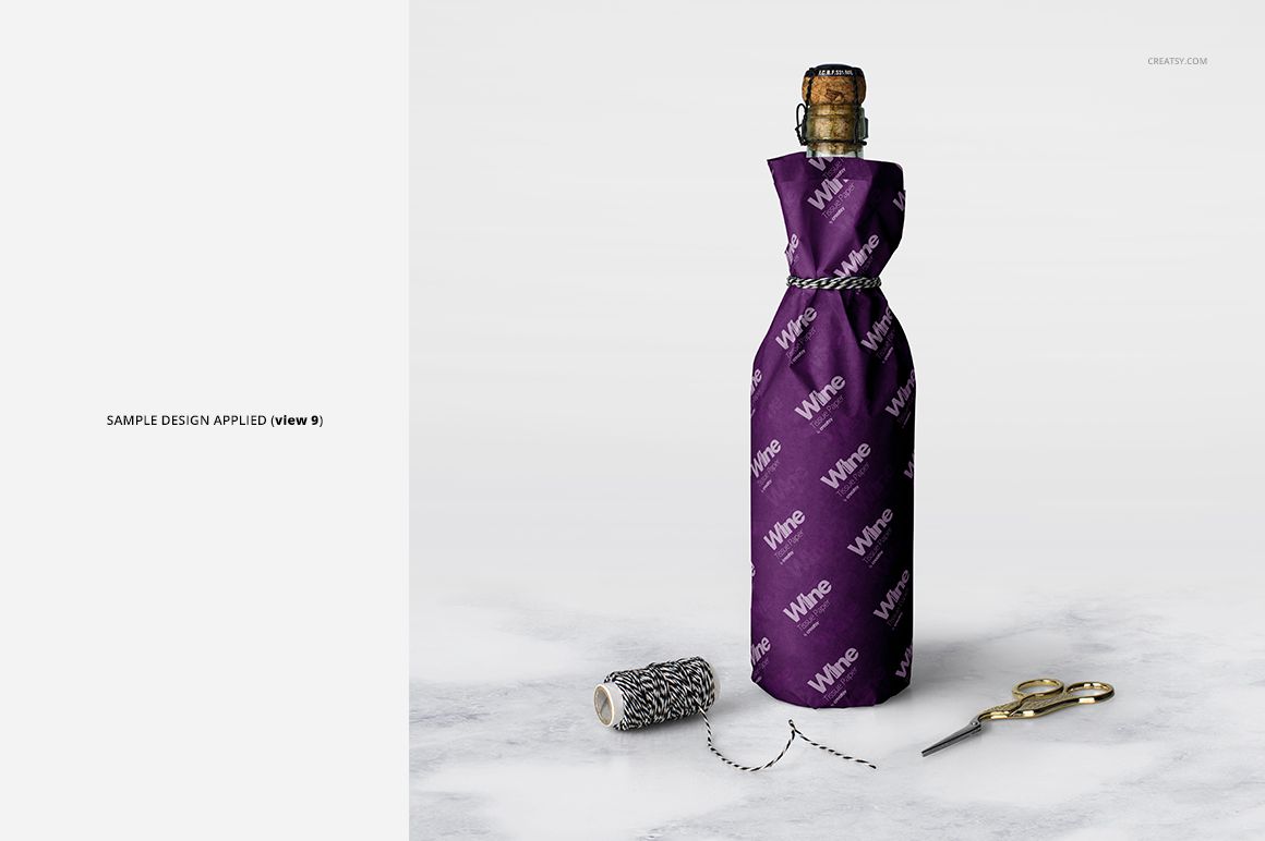 Wine wrapping tissue paper mockup featuring a corked bottle wrapped in purple paper, with black and white twine and gold scissors.